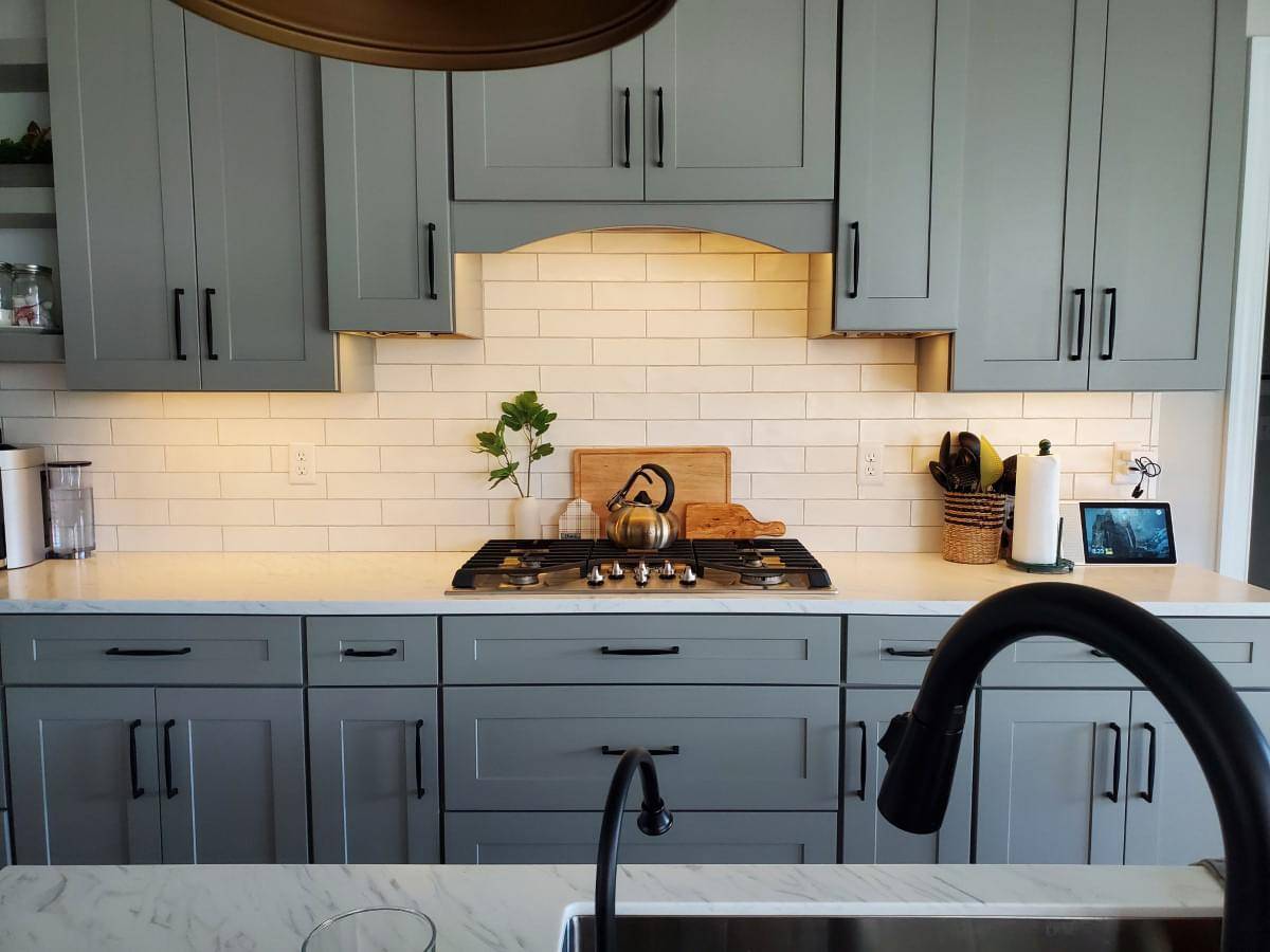 a kitchen stove with custom kitchen lighting